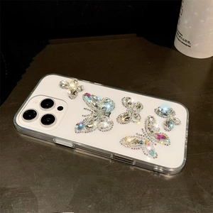 Detail of 3D crystal butterfly ornaments on clear iPhone case with rhinestone bowknots