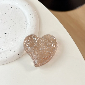 Macro view of transparent glitter heart phone grip with sparkling silver sequins