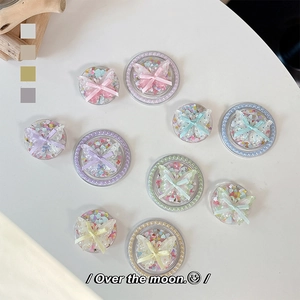 Detail of acrylic butterfly phone grip with colorful sequins and ribbon bow decorations