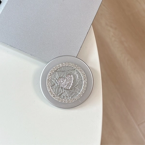 Detail of silver MagSafe phone grip with sparkling rhinestones and heart motif