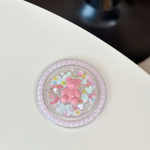 Détail d'un support de téléphone ours rose 3D avec paillettes et perles