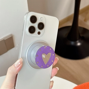 Purple round magnetic phone grip with silver heart mirror and mi me text on white phone