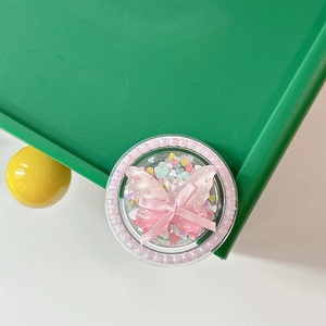 Detail of a cute bow and butterfly resin phone grip with pink beaded edge decoration