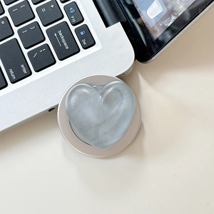 Close-up of heart-shaped phone grip with grey marble texture and metallic base