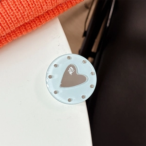 Detail of light blue translucent phone socket with heart mirror and mine lettering