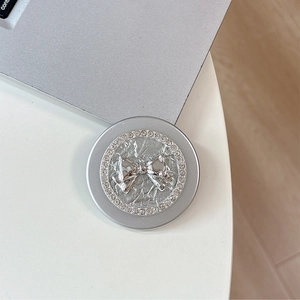 Macro view of silver Magsafe phone grip featuring a crystal-studded ribbon design