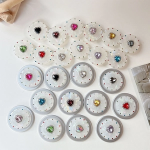 Macro detail of magnetic telescopic phone stand featuring colorful heart rhinestones
