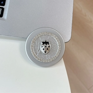 Detail of magnetic phone socket with 3D strawberry emblem and crystal rhinestone border