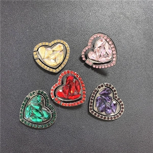 Detail of heart-shaped phone ring holders in five colors with sparkling rhinestones
