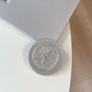 Detailed view of silver magnetic phone grip with rhinestone bow and sparkling diamond rim