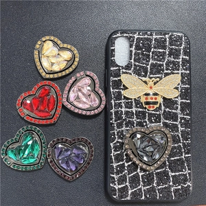 Macro shot of heart-shaped rhinestone phone ring holders in six various vibrant colors