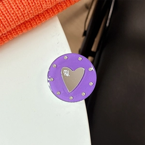 Macro shot of purple round phone grip with crystal border and heart mirror detail