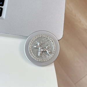 Close-up of silver magnetic phone grip featuring a rhinestone balloon dog ornament
