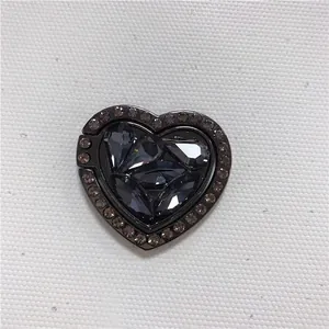 Detail of heart-shaped metal phone ring holder in gunmetal grey with sparkling rhinestones