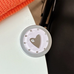 Macro shot of mirror heart phone grip with rhinestones and mi ne text on purple base