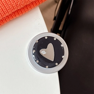 Close-up of heart mirror phone grip with mine text and silver dots decoration