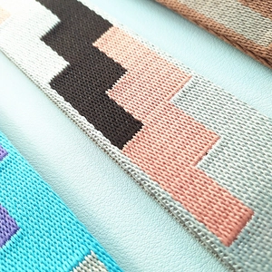 Macro view of woven geometric zigzag pattern replacement strap for shoulder bags