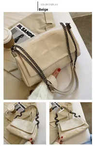 Detail view of beige PU leather crossbody bag with quilted texture and thick metal chain