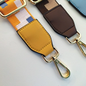 Close-up of colorful adjustable replacement bag straps with gold metal lobster clasps