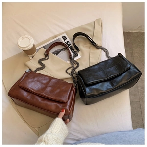 Detail of vintage PU leather bags with diamond stitching and metal chain straps
