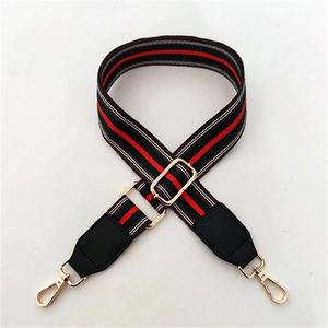 Adjustable striped nylon bag strap with golden metal hardware and leather connectors