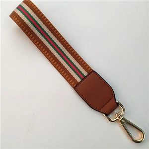 Brown woven wrist strap with red green stripe and gold lobster clasp for bags
