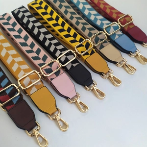 Adjustable woven shoulder straps with herringbone pattern and gold metal hooks