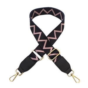 Adjustable wide replacement bag strap with pink zigzag pattern and gold metal hooks