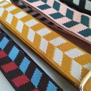 Close-up of adjustable woven shoulder straps with geometric jacquard and metal buckle