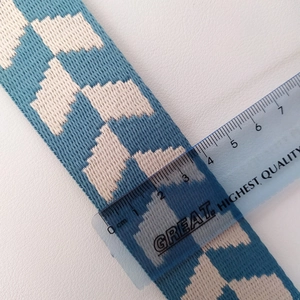 Detail shot of a 3.8cm wide blue and white checkered woven strap with measuring ruler