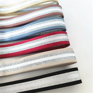 Detailed view of colorful striped bag straps with shiny silver glitter thread insets