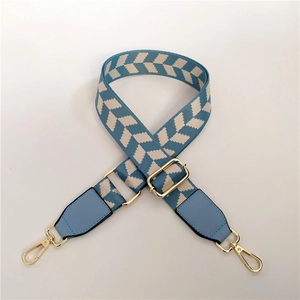 Detail of adjustable blue and white checkered strap with gold swivel hooks and leather ends
