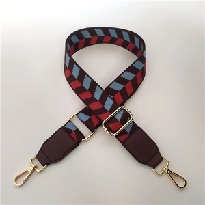 Close-up of retro plaid pattern wide strap with gold metal buckles and adjustable length