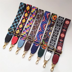Detail of adjustable ethnic style bag straps with colorful patterns and gold hardware