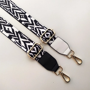 Detail of adjustable wide shoulder straps with geometric patterns and gold metal buckles
