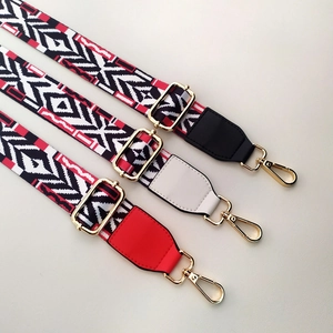 Close-up of adjustable ethnic geometric woven shoulder straps with gold-tone hardware