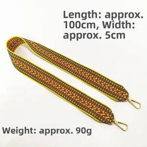 Close-up of wide colorful ethnic embroidery strap with gold lobster clasps and size specs