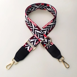 Adjustable wide shoulder strap with red and black geometric pattern and gold hooks