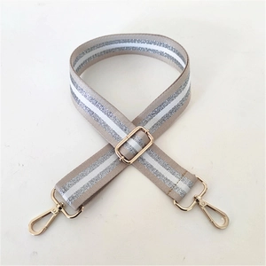 Adjustable wide canvas bag strap featuring silver glitter stripes and gold metal hardware