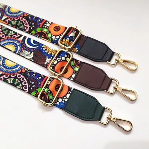 Close-up of adjustable colorful ethnic pattern bag straps with gold metal clasps