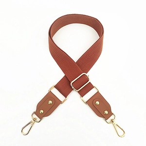 Adjustable wide cotton shoulder strap with reddish-brown webbing and gold hardware