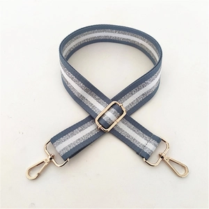 Close-up of adjustable blue-grey strap with silver glitter stripes and gold metal hooks