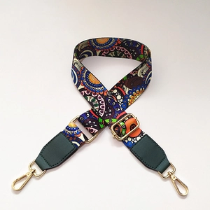 Adjustable bohemian floral woven strap with green leather ends and gold metal hooks