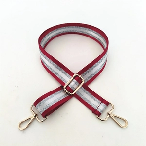 Close-up of adjustable red and silver sequin strap with gold lobster clasps and buckles