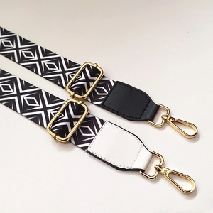 Close-up of adjustable wide straps with black and white diamond patterns and gold buckles