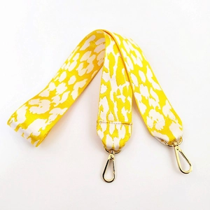 Wide shoulder bag strap with yellow leopard print and gold metal lobster clasps
