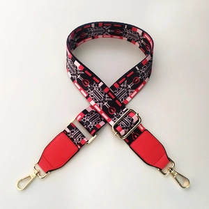 Detail of adjustable woven strap with ethnic patterns and gold lobster hooks