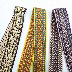 Detail of colorful bohemian jacquard woven straps with geometric arrow embroidery patterns