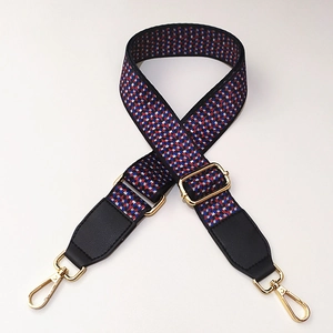 Close-up of geometric woven replacement bag strap with gold metal hardware and leather ends