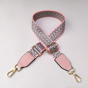Detail of adjustable colorful woven strap with pink PU leather and golden hardware